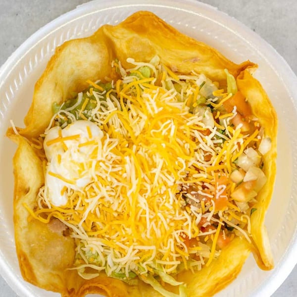 A Giliberto's Mexican Taco Shop taco salad in a crispy fried tortilla bowl with cheese and sour cream.